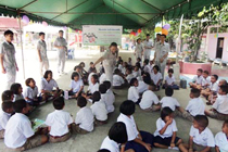 image : Employees teach elementary school children about the dangers of drugs
